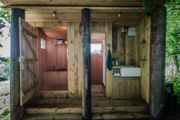 Separate timber shower and toilet block